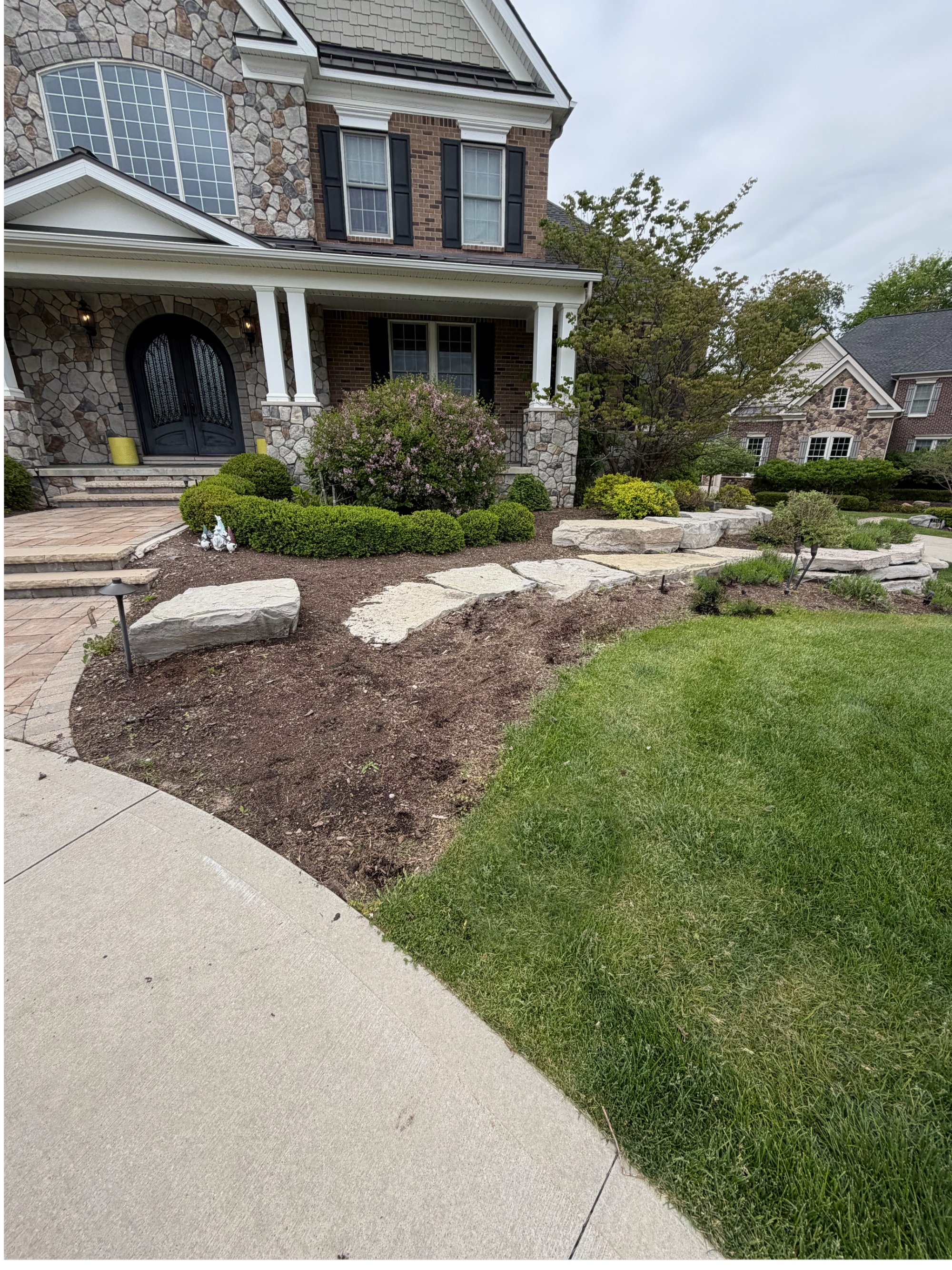 Same front yard beds before, with bare soil and tired beds